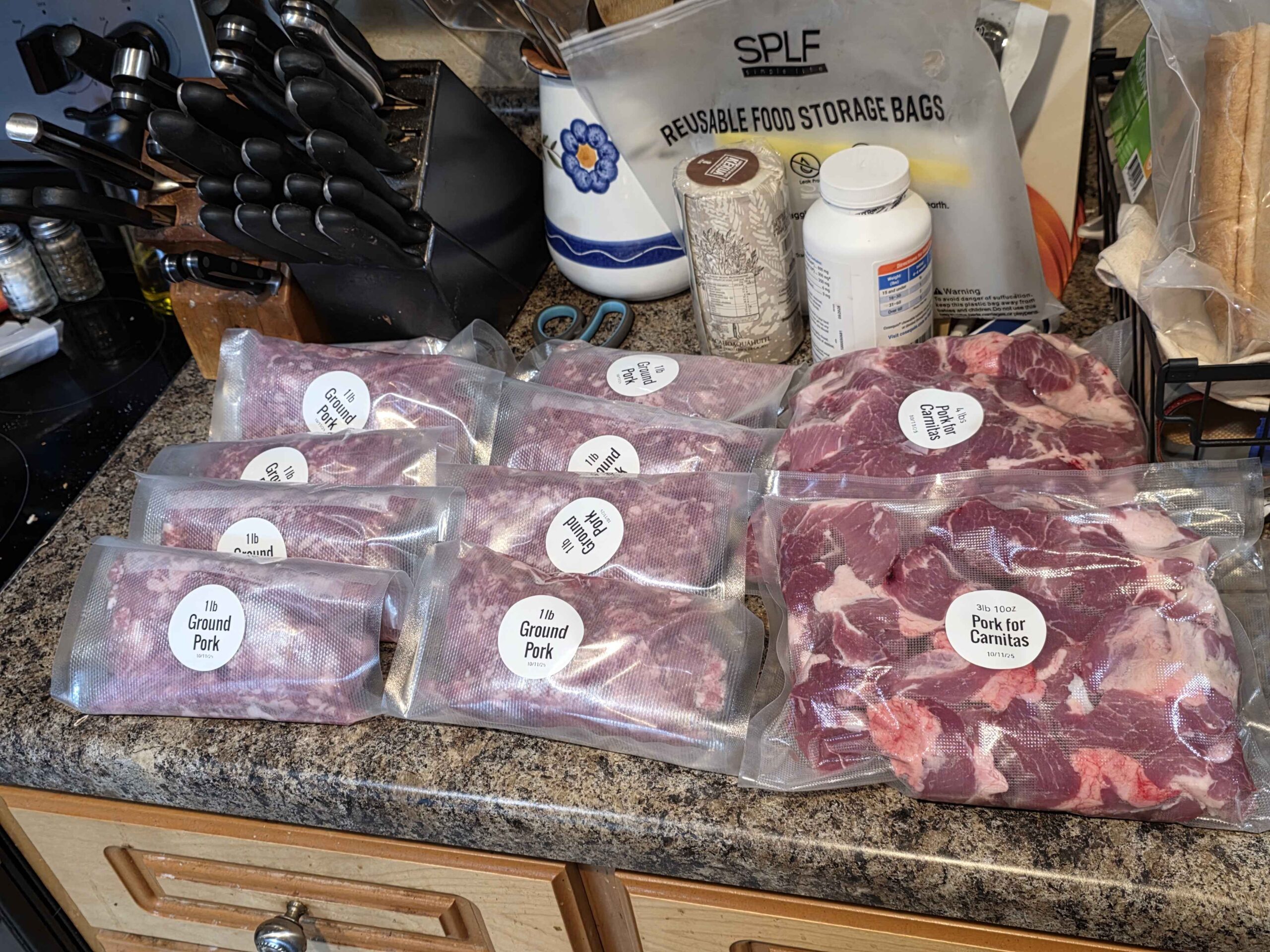 Vacuum sealed and labeled meat: 8 small packs with 1 pound of ground pork, and two big packs with 3-4 lbs of chopped up pieces that we use for carnitas.