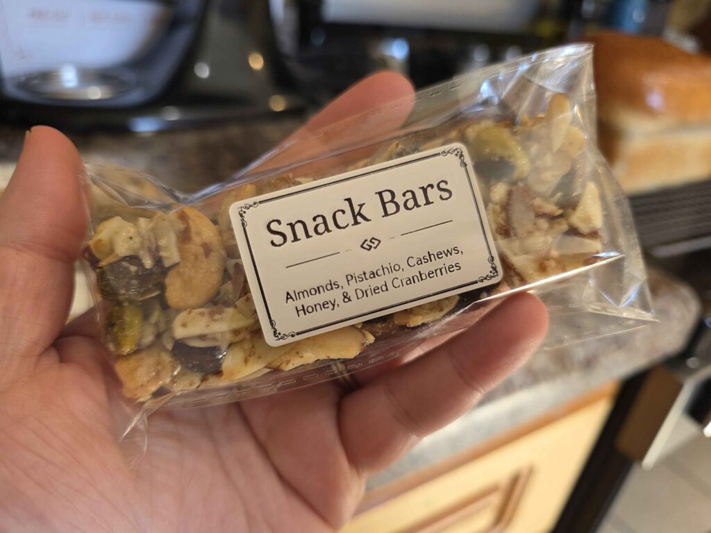 my hand holding a nicely packaged and labeled snack bar