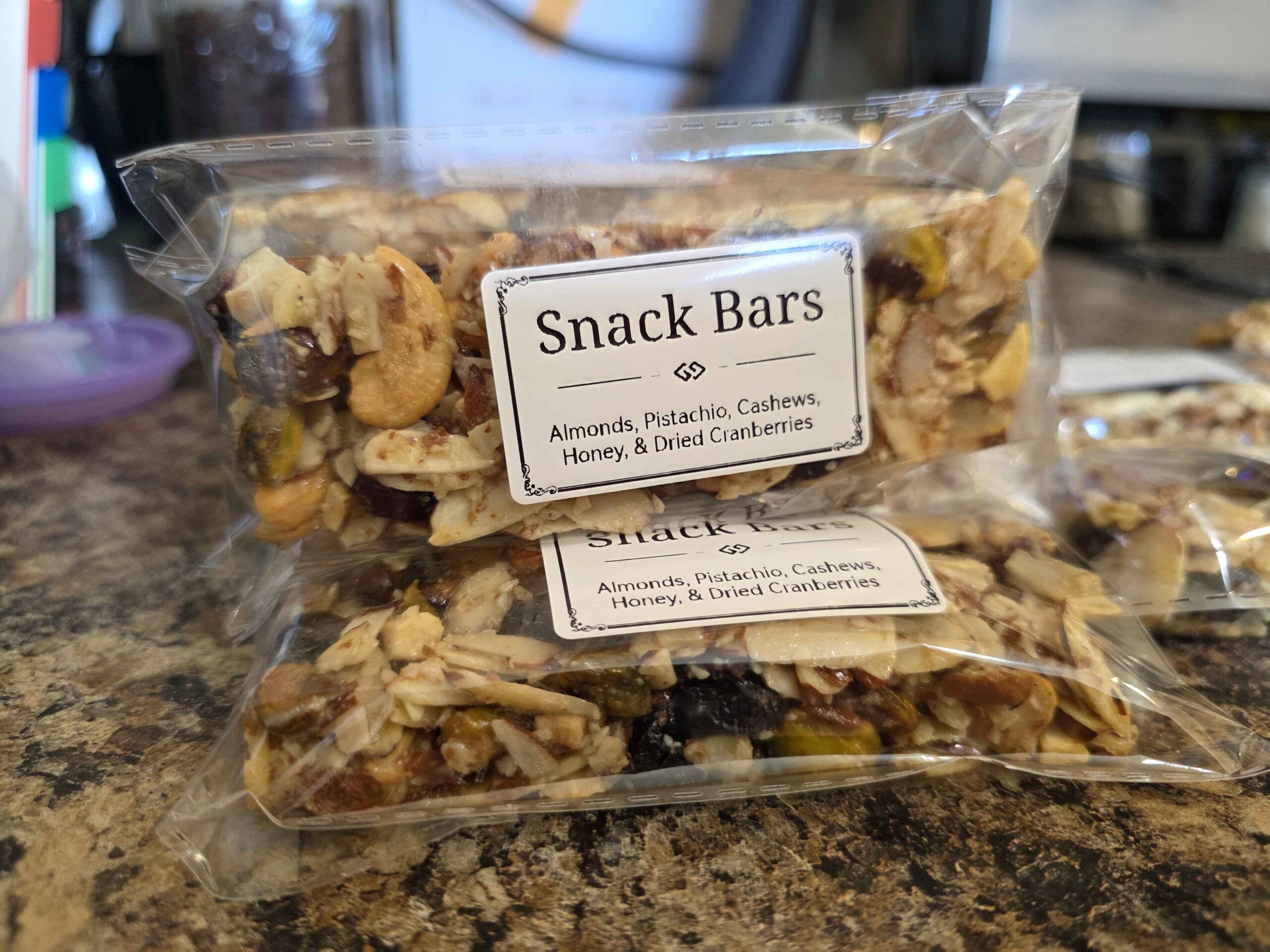 A photo of several packaged snack bars with cute little labels. You can tell they are mostly nuts held together with honey and dreams.