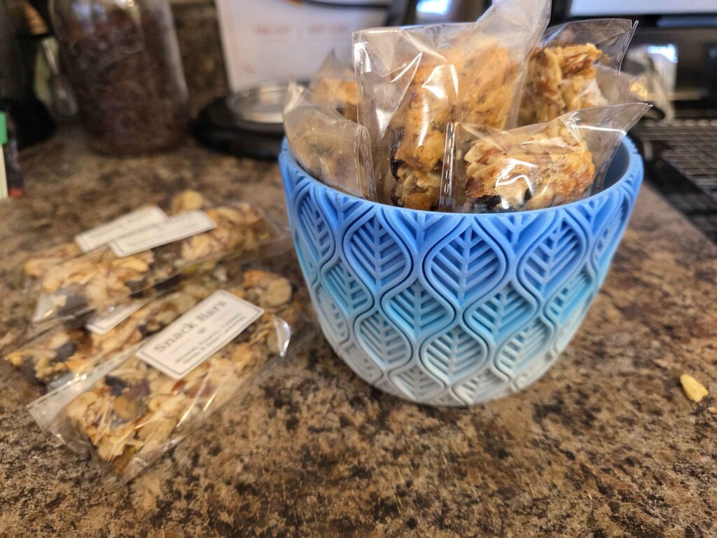 Snack bars on the counter next to a 3d printed bowl I made to put them in the fridge.