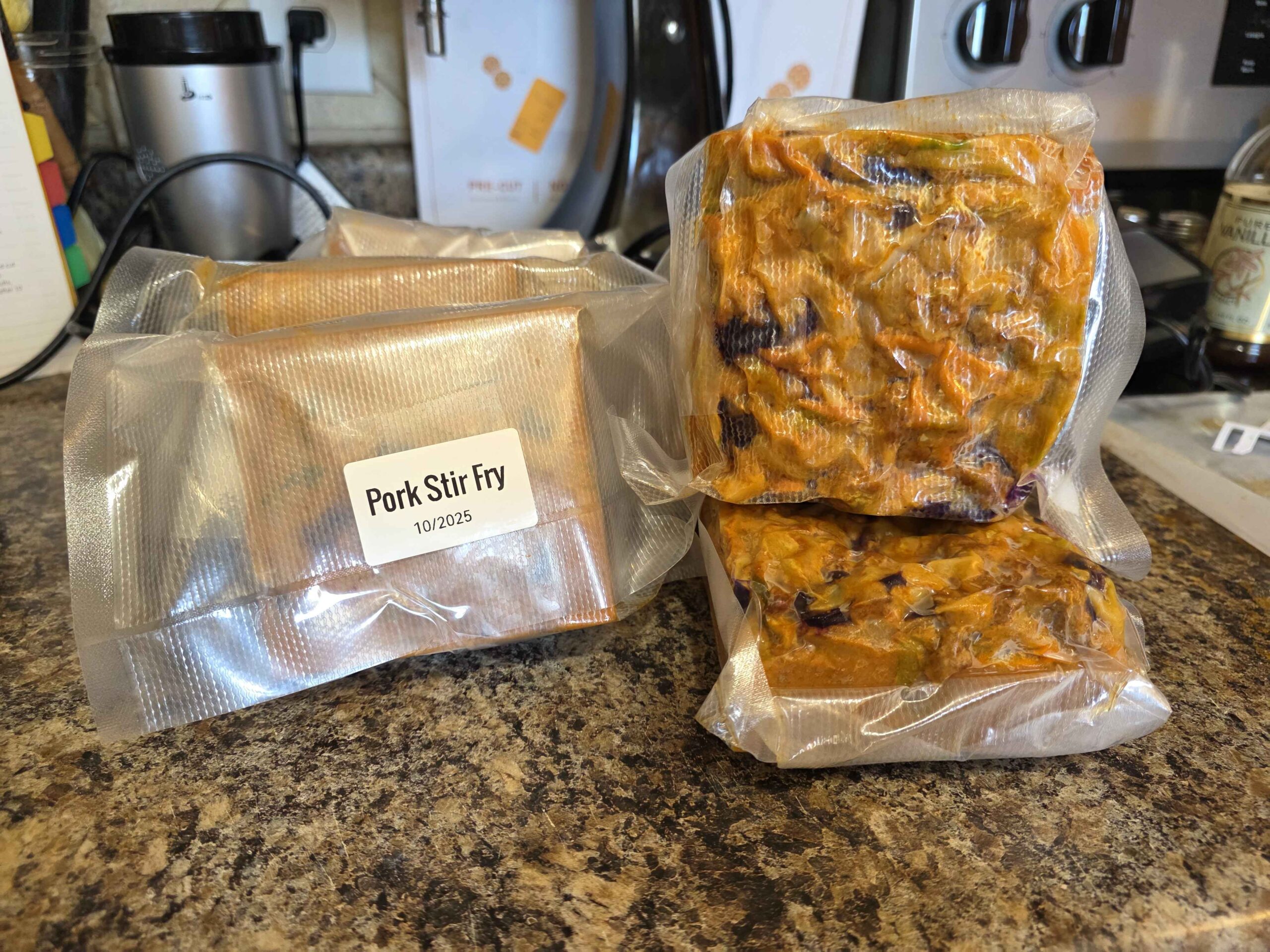 Seven vacuum sealed double servings of our Pork Stir Fry, frozen and labeled