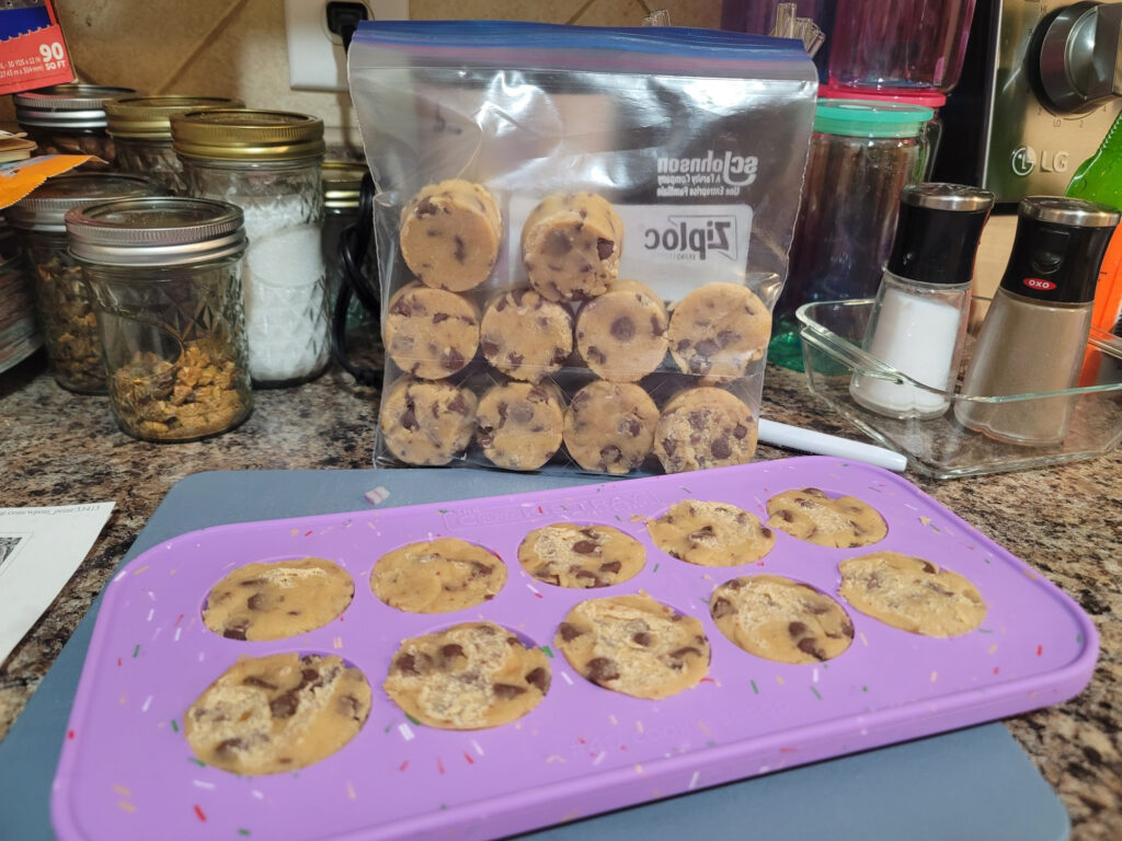 One of the trays in front of a quart sized bag where I've already put the first 10 cookies in neat rows of four. All 20 fit perfectly.
