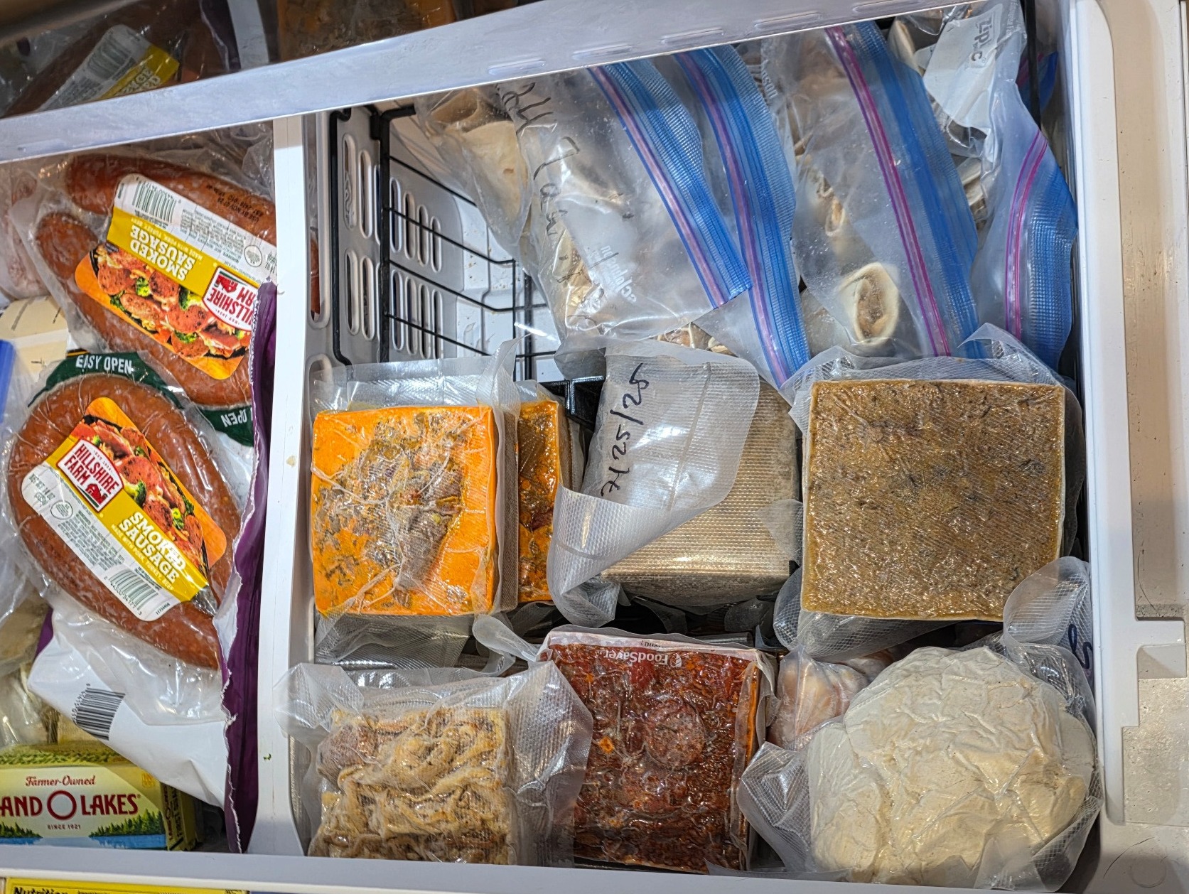 a picture of my freezer drawer, which is stacked full of frozen cubes of food!