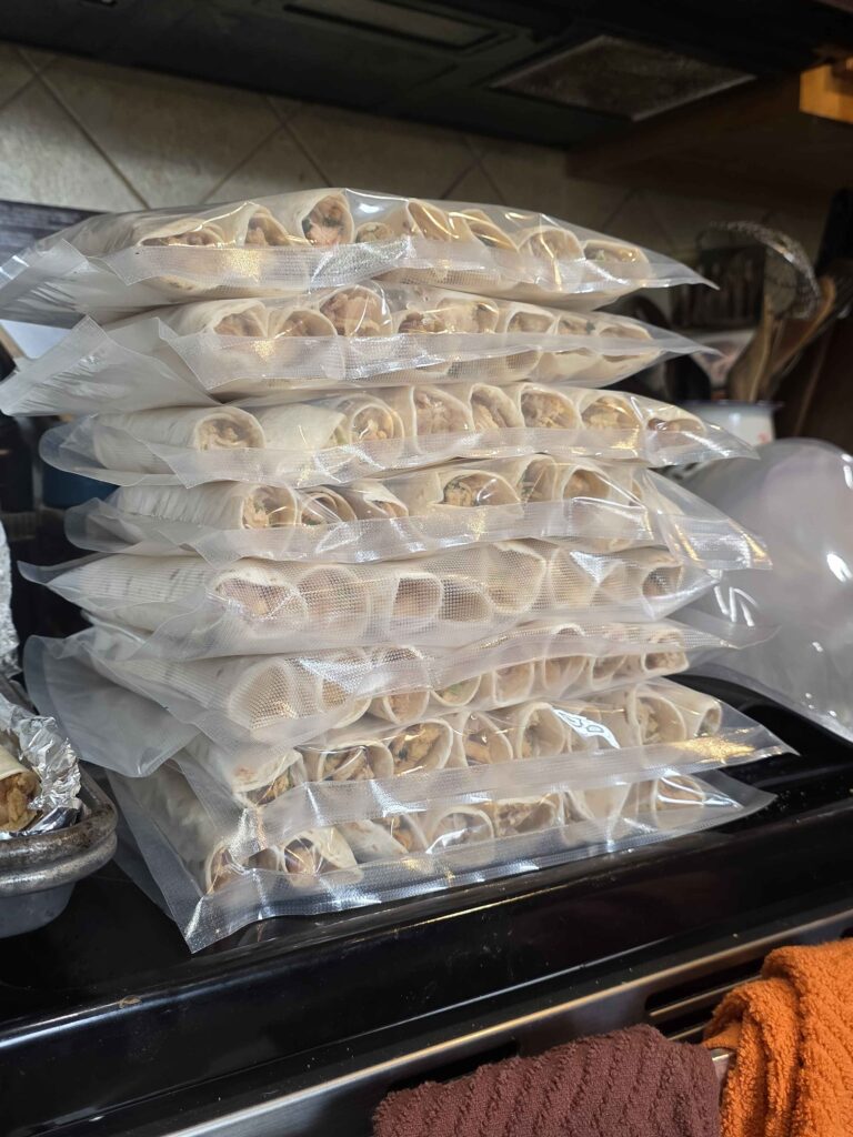 a stack of taquitos that have been bagged up, 6 per bag, and vacuum sealed